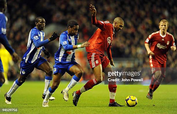David Ngog of Liverpool battles with Charles N'zogbia of Wigan during the Barclays Premier League match between Liverpool and Wigan Athletic at...