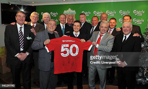 Ian St John and Kevin Keegan hold up a signed shirt while posing with fellow members of Bill Shankly's team during the Barclays Premier League match...