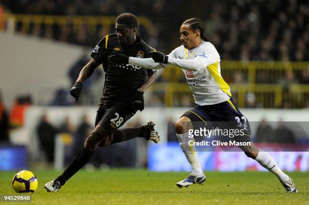 Kolo Toure of Manchester City is challenged by Benoit Assou-Ekotto of Spurs during the Barclays Premier League match between Tottenham Hotspur and...