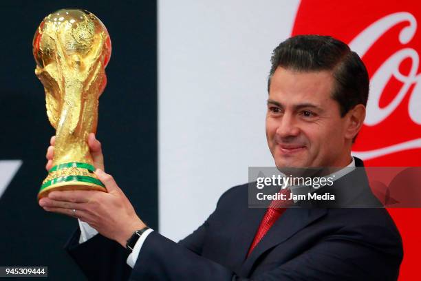 Enrique Pena Nieto, President of Mexicoholds the FIFA Trophy during the FIFA Trophy Tour at Residencia Oficial de Los Pinos on April 11, 2018 in...