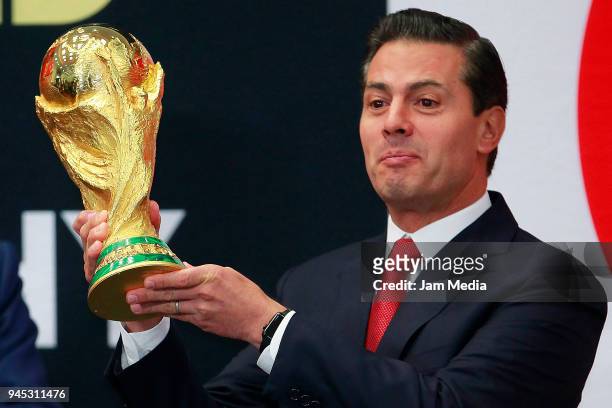 Enrique Pena Nieto, President of Mexicoholds the FIFA Trophy during the FIFA Trophy Tour at Residencia Oficial de Los Pinos on April 11, 2018 in...