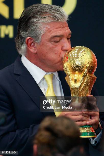 Argentinian former soccer player Hector Miguel Zelada kisses the FIFA Trophy during the FIFA Trophy Tour at Residencia Oficial de Los Pinos on April...
