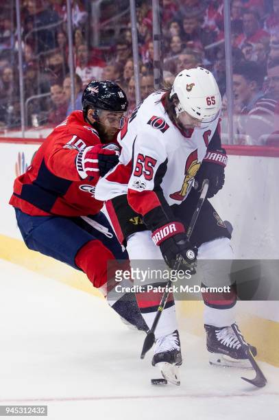 Erik Karlsson of the Ottawa Senators and Brett Connolly of the Washington Capitals battle for the puck in the first period at Capital One Arena on...
