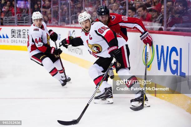 Erik Karlsson of the Ottawa Senators and Brett Connolly of the Washington Capitals battle for the puck in the first period at Capital One Arena on...