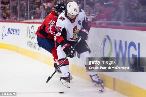Erik Karlsson of the Ottawa Senators and Brett Connolly of the Washington Capitals battle for the puck in the first period at Capital One Arena on...
