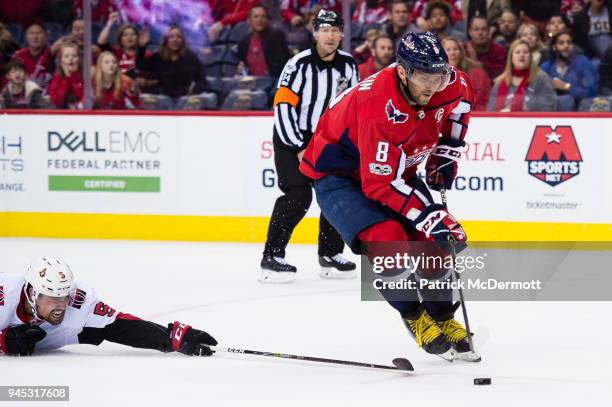 Alex Ovechkin of the Washington Capitals shoots and scores a goal as Cody Ceci of the Ottawa Senators defends in the first period at Capital One...