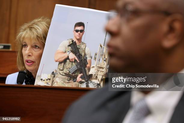 House Armed Services Committee member Rep. Jackie Speier holds a photograph of Air Force Staff Sgt. Logan Ireland while questioning Defense Secretary...