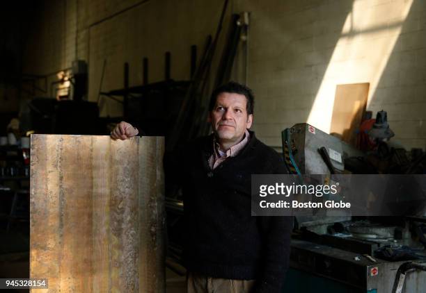 Artist Pablo Eduardo poses for a portrait in Chelsea, MA with the bronze that will be used to create his three Boylston Street memorials to the...