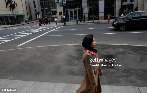 Woman walks past the site of one of the Boston Marathon bombings on Boylston Street in Boston on April 11, 2018. The site will soon be marked by a...