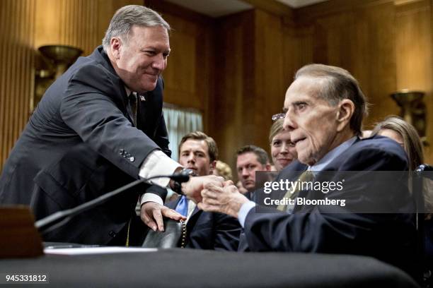 Michael Pompeo, director of the Central Intelligence Agency and U.S. Secretary of state nominee for President Donald Trump, left, shakes hands with...