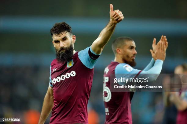 Mile Jedinak and Lewis Grabban of Aston Villa applaud the supporters following the Sky Bet Championship match between Aston Villa and Cardiff City at...