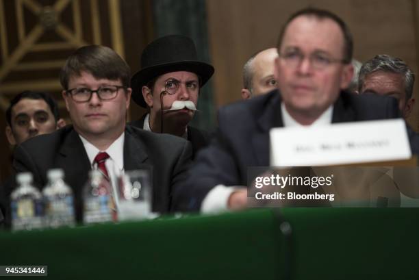 An attendee dressed as the "Monopoly Man" listens during a Senate Banking, Housing & Urban Affairs Committee hearing with Mick Mulvaney, acting...