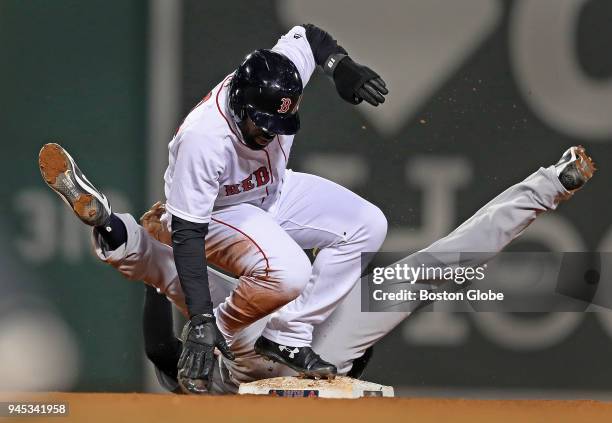 Boston Red Sox player Jackie Bradley, Jr. And Yankees shortstop Didi Gregorius get tangled up during a bottom of the sixth inning force out at second...