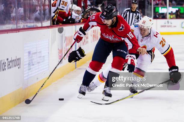 Chandler Stephenson of the Washington Capitals and Freddie Hamilton of the Calgary Flames battle for the puck in the third period at Capital One...