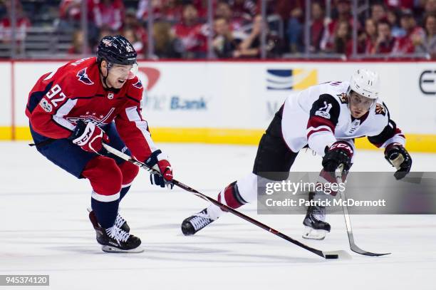 Evgeny Kuznetsov of the Washington Capitals battles for the puck against Brendan Perlini of the Arizona Coyotes in the first period at Capital One...