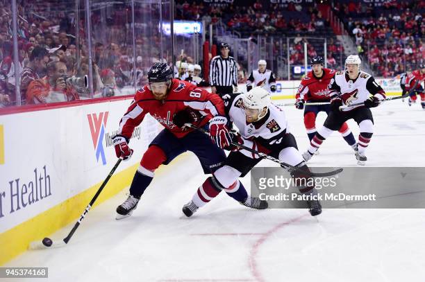 Liam O'Brien of the Washington Capitals and Dakota Mermis of the Arizona Coyotes battle for the puck in the first period at Capital One Arena on...