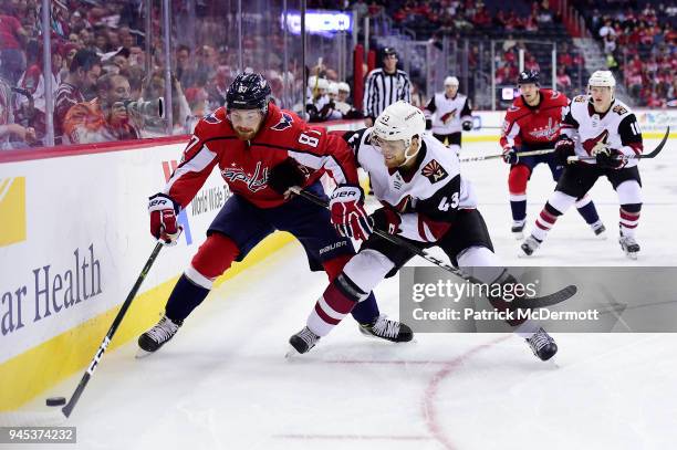 Liam O'Brien of the Washington Capitals and Dakota Mermis of the Arizona Coyotes battle for the puck in the first period at Capital One Arena on...