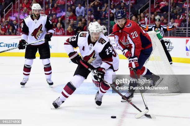 Oliver Ekman-Larsson of the Arizona Coyotes and Lars Eller of the Washington Capitals battle for the puck in the third period at Capital One Arena on...