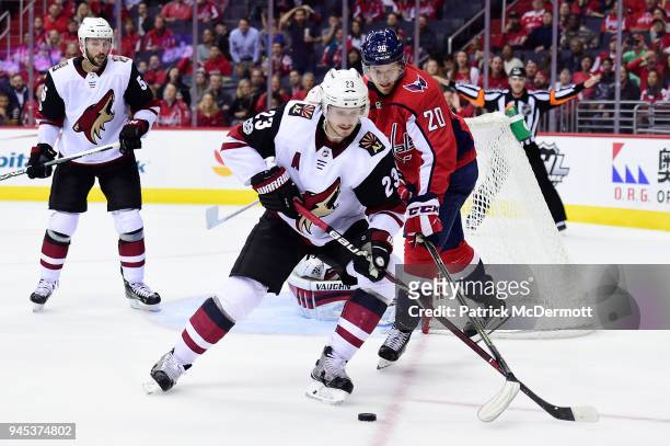 Oliver Ekman-Larsson of the Arizona Coyotes and Lars Eller of the Washington Capitals battle for the puck in the third period at Capital One Arena on...