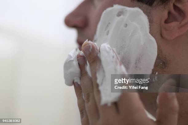 man applying shaving foam to face - shaving cream stock pictures, royalty-free photos & images