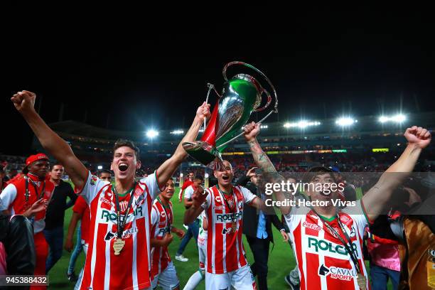 Igor Lichnovsky of Necaxa, Carlos Gonzalez of Necaxa and Marcelo Allende of Necaxa celebrate with the champion trophy during the Championship match...