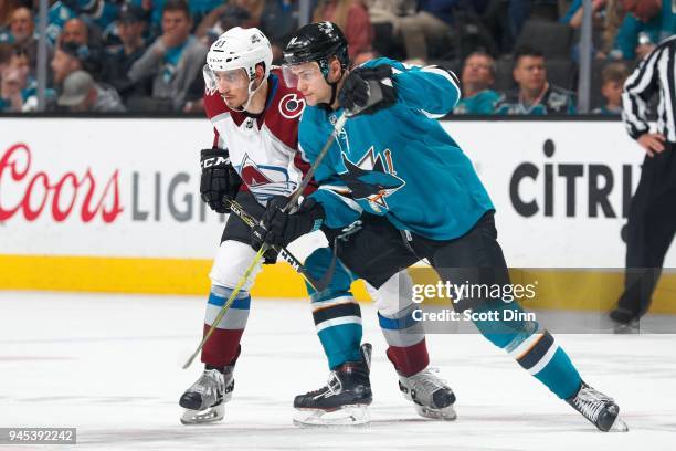 Dylan Gambrell of the San Jose Sharks jostles for position with Matt Nieto of the Colorado Avalanche at SAP Center on April 5, 2018 in San Jose,...