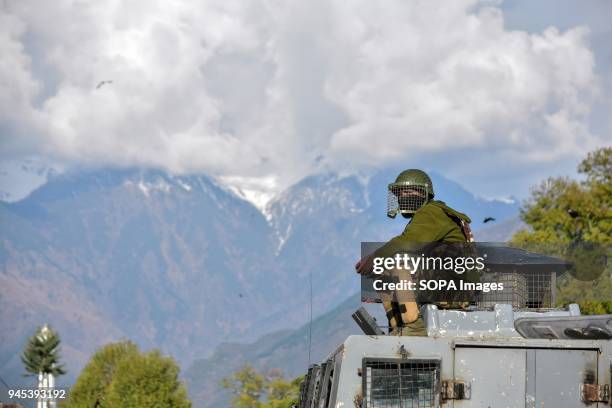 An Indian paramilitary trooper sits on the roof of the police vehicle during clashes in Srinagar, Indian administered Kashmir. As Muslim majority...