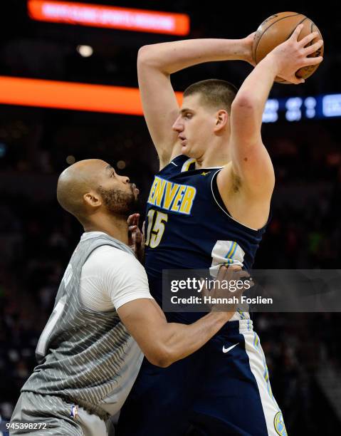 Taj Gibson of the Minnesota Timberwolves defends against Nikola Jokic of the Denver Nuggets during the third quarter of the game on April 11, 2018 at...