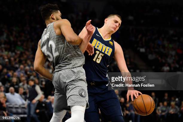 Karl-Anthony Towns of the Minnesota Timberwolves defends against Nikola Jokic of the Denver Nuggets during the third quarter of the game on April 11,...