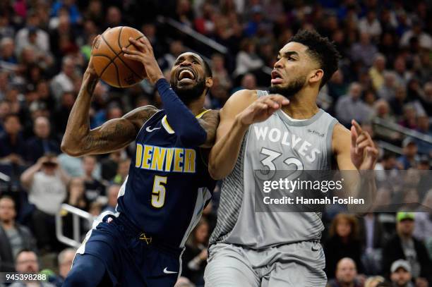 Karl-Anthony Towns of the Minnesota Timberwolves defends against Will Barton of the Denver Nuggets during the fourth quarter of the game on April 11,...