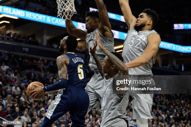 Jimmy Butler, Jamal Crawford and Karl-Anthony Towns of the Minnesota Timberwolves defend against Will Barton of the Denver Nuggets during the fourth...