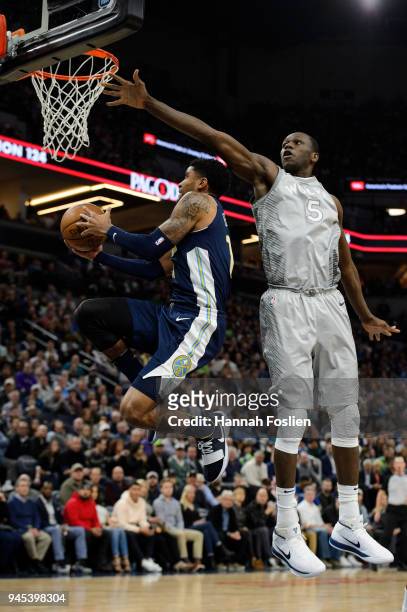 Gorgui Dieng of the Minnesota Timberwolves defends against Gary Harris of the Denver Nuggets during the fourth quarter of the game on April 11, 2018...