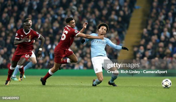 Manchester City's Leroy Sane goes down under the challenge from Liverpool's Trent Alexander-Arnold who received a Yellow Card for the offence during...