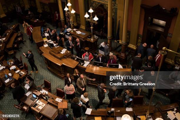 Lawmakers exit the floor as Flint residents and allies from regions nearby disrupt the state legislature with a chant in protest of the closing water...