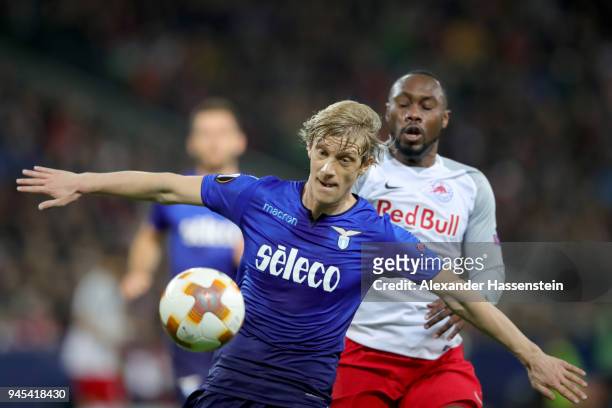 Dusan Basta of Lazio battles for the ball with Reinhold Yabo of Salzburg during the UEFA Europa League quarter final leg two match between RB...