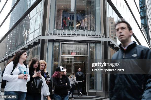 People walk by the newly opened Nordstrom menÕs store, the companyÕs first-ever Manhattan location in midtown at 57th and Broadway on April 12, 2018...