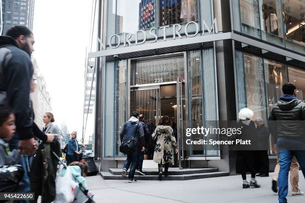 People walk by the newly opened Nordstrom menÕs store, the companyÕs first-ever Manhattan location in midtown at 57th and Broadway on April 12, 2018...