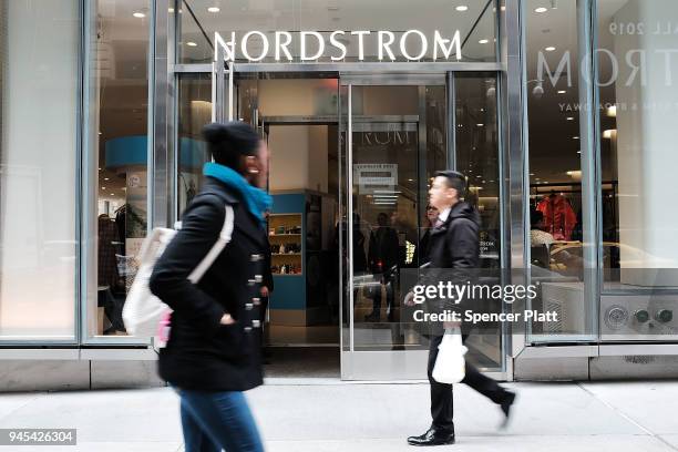 People walk by the newly opened Nordstrom menÕs store, the companyÕs first-ever Manhattan location in midtown at 57th and Broadway on April 12, 2018...