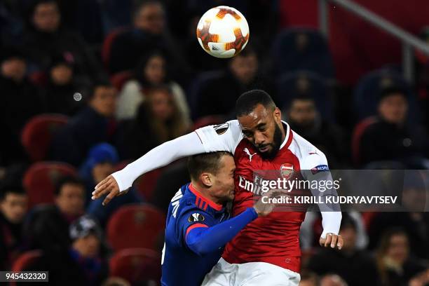 Arsenal's French striker Alexandre Lacazette vies for the ball against CSKA Moscow's Russian defender Aleksei Berezutski during the UEFA Europa...