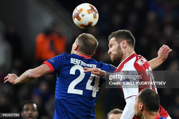 Arsenal's German defender Shkodran Mustafi vies CSKA Moscow's Russian defender Vasili Berezutski during the UEFA Europa League second leg...