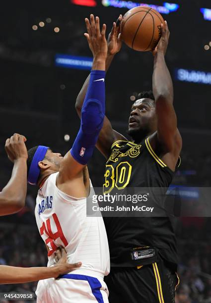 Julius Randle of the Los Angeles Lakers shoots over Tobias Harris of the LA Clippers in the first half at Staples Center on April 11, 2018 in Los...