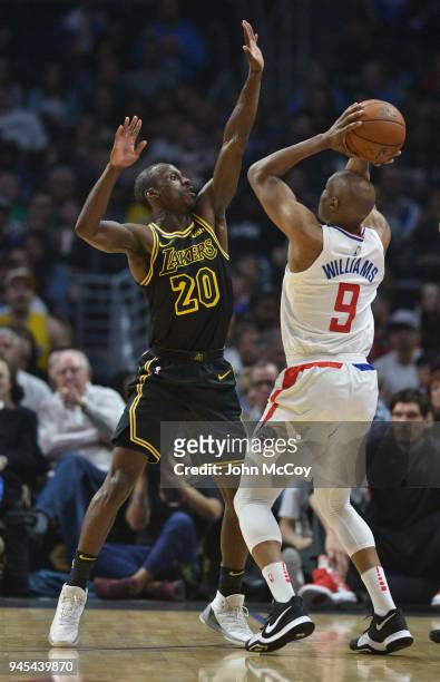 Andre Ingram of the Los Angeles Lakers guards C.J. Williams of the LA Clippers in the first half at Staples Center on April 11, 2018 in Los Angeles,...