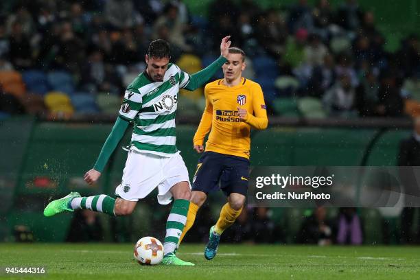 Sporting's defender Andre Pinto from Portugal vies with Atletico Madrids forward Antoine Griezmann of France during the UEFA Europa League second leg...