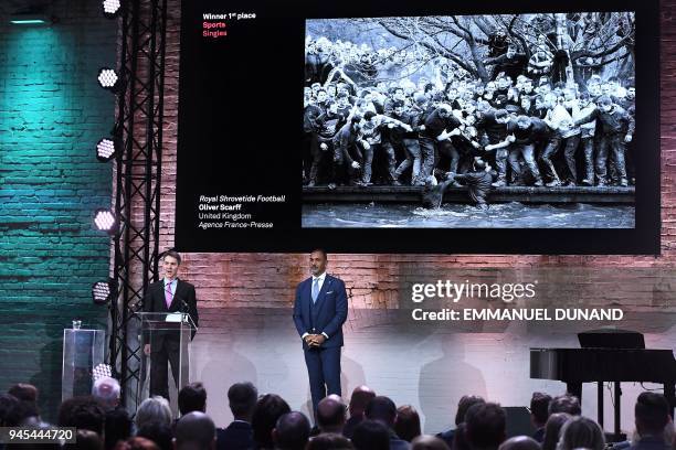British AFP photographer Oliver Scarff speaks next to Dutch former football player Ruud Gullit in Amsterdam on April 12, 2018 during the 2018 World...