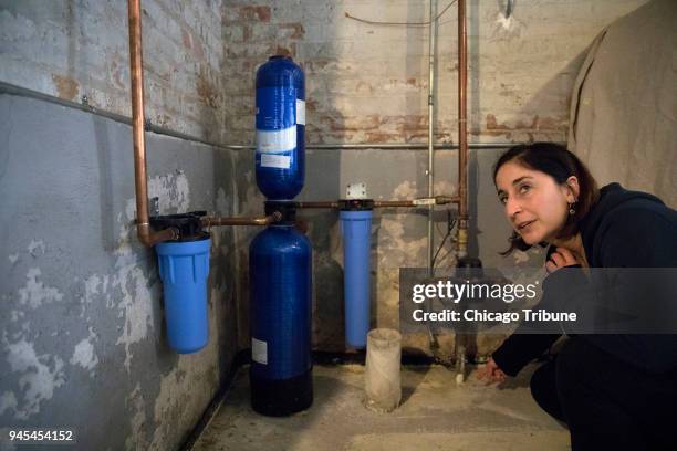 Jenny Abrahamian explains the process of her whole house water system at her home on Wednesday, April 4 in Chicago, Ill. After high lead levels were...