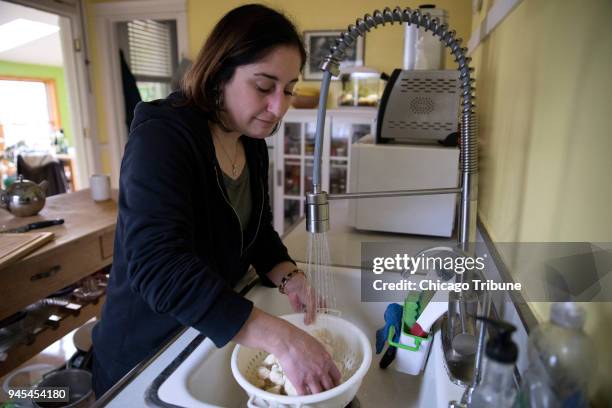 Jenny Abrahamian rinses cauliflower at her home on Wednesday, April 4 in Chicago, Ill. After high lead levels were discovered in her tap water by a...