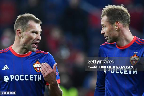 Moscow's Russian defender Aleksei Berezutski and CSKA Moscow's Russian defender Vasili Berezutski react after the UEFA Europa League second leg...