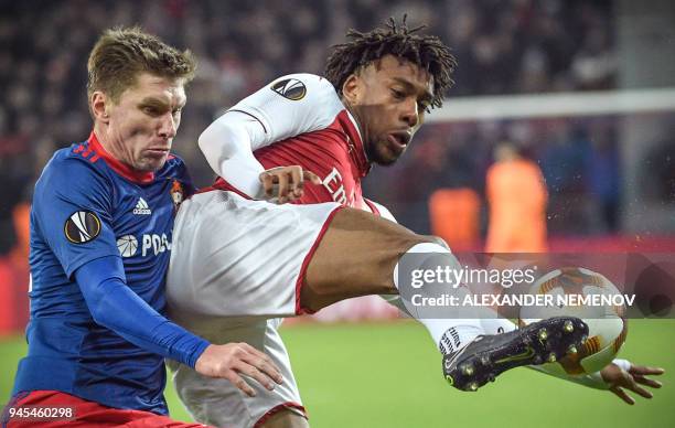 Moscow's Russian defender Kirill Nababkin vies with Arsenal's Nigerian striker Alex Iwobi during the UEFA Europa League second leg quarter-final...