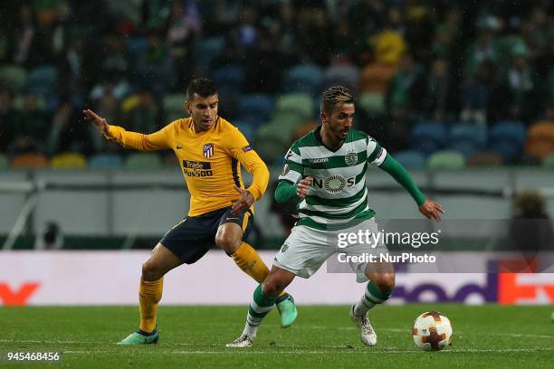 Sporting's midfielder Ruben Ribeiro from Portugal vies with Atletico Madrids forward Angel Correa of Argentina during the UEFA Europa League second...