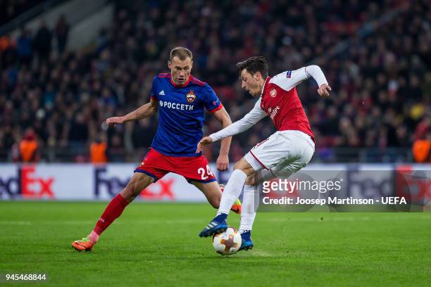 Mesut Ozil of Arsenal dribbles against Vasili Berezutski of CSKA Moskva during the UEFA Europa League quarter final leg two match between CSKA Moskva...